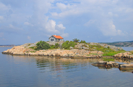 Petite maison sur un ilôt d'un lac suédois